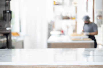 Selective focus and blurred background of beautiful bright and white decorative kitchen with people or chef is working to prepare delicious meal, food and bakery for lunch or dinner.