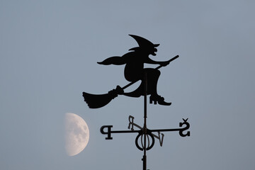 Wind chime. Grandma on a broom. The evening moon in the background.