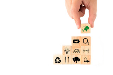 Ideas to save the environment for World Environment Day. hand picking up wooden blocks with Earth icon on top. energy saving, clean energy, reforestation, increase oxygen, reduce fuel consumption.