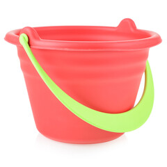 Red toy bucket made of plastic or rubber, close-up, isolate on a white background. Children's toys for playing in the sandbox or on the beach. Development of fine motor skills of the child