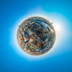 Aerial early spring or autumn city view with crossroads and roads, houses, buildings, parks and bridges. Copter shot. Little planet sphere mode. Spherical panorama of the city, Yekaterinburg, Russia.