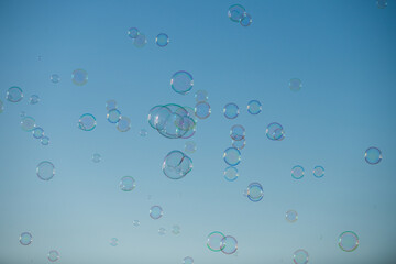 Many soap bubbles. Colorful soap bubble on the blue sky.