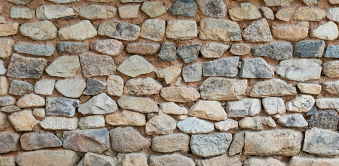 roadside stone wall. The texture of the stone.
