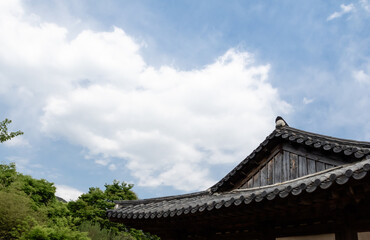 Blue sky seen over the roof of a traditional Korean house