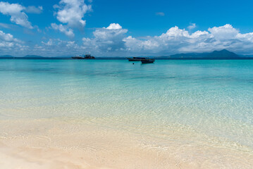 Sandy beach with clean and transparent water with ripple and pattern in Semporna, Sabah, Borneo