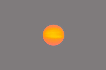 Orange sun disk isolated on smoky sky