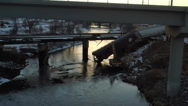 TRAIN HANGING OFF A BRIDGE FROM DERAIL
