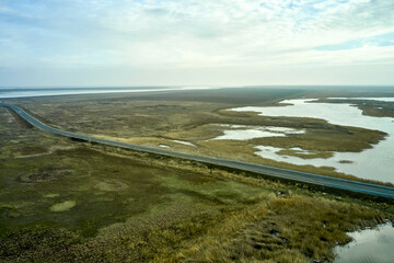 steppe landscape road and lake in the steppe and blue sky