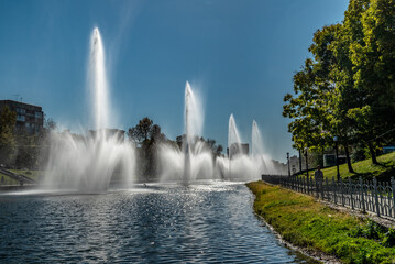 Fountains in the public park on a sunny autumn day 
