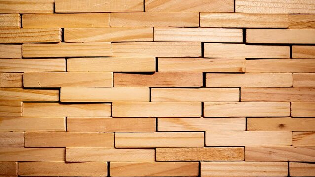 Stop motion of wooden brick forming into a wall 