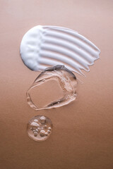 Cream, hyaluronic gel and serum on a beige background.