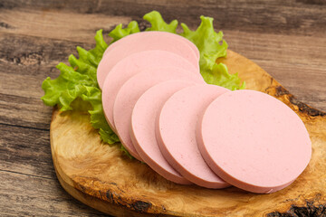 Sliced sausage snak over board © Andrei Starostin