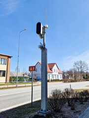 White static speed or safety camera and antenna against a blue sky. Photo radar.
