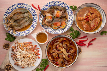 Seafood Sashimi set Fresh shrimp, Mantis shrimps, fresh blue crab, fresh salmon marinated in soy sauce and steamed blue crab, served with spicy seafood dipping sauce.