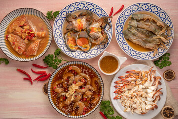 Seafood Sashimi set Fresh shrimp, Mantis shrimps, fresh blue crab, fresh salmon marinated in soy sauce and steamed blue crab, served with spicy seafood dipping sauce.