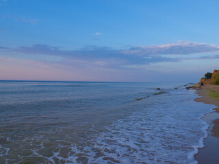 Fototapeta na wymiar The Beauty of morning waves. Seascape with empty coastline of sand beach in Ukraine. The waters edge sealine beach near Odesa