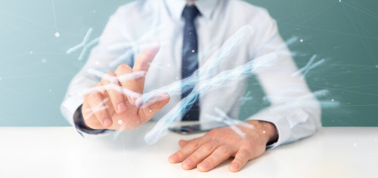 Businessman Holding A Group Of Chromosome With DNA Inside Isolated On A Background 3d Rendering