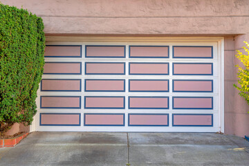 Garage door with white grid trims and pink panels with blue frames at San Francisco, California
