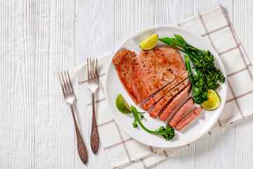 fried tuna steak with boiled broccolini and lime