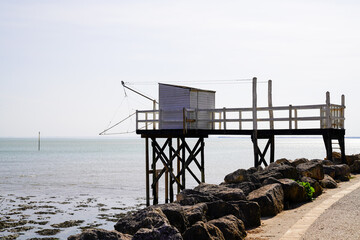 Fototapeta na wymiar wooden fishing huts on stilts in sunset Saint-Palais-sur-Mer France