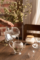brewing flower tea in a glass teapot lifestyle