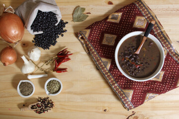 Black Bean Chili on Wooden Table With Spices and Dried Black Beans