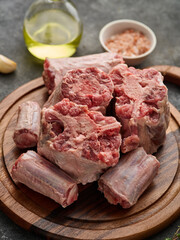 Raw and fresh oxtail on a wooden cutting board.