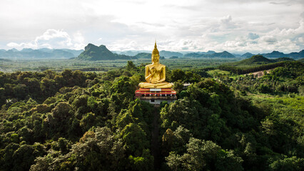 A buddha statue is standing on a mountain top in Chumphon region Thailand