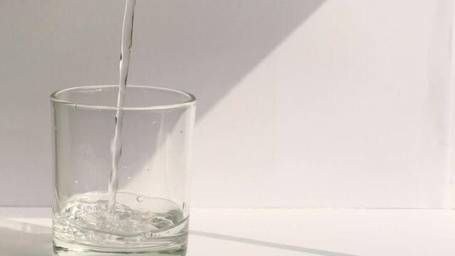 Close up glass of water.Pouring clean fresh water in transparent glass  isolated on white  background.  Feel refreshing morning. Healthy Concept.