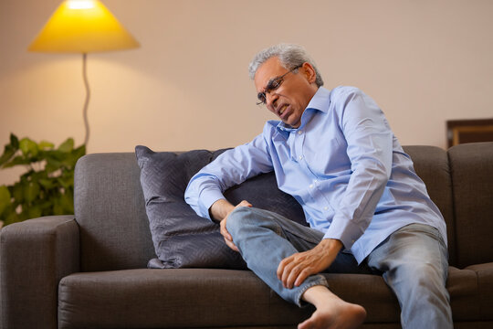 Portrait Of A Senior Man Suffering From Knee Pain 