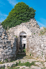 Ruins of abandoned Trulli or Trullo house, traditional Apulian dry stone hut with a conical roof...