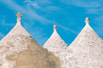 White roof of beautiful Trulli or Trullo house, traditional Apulian dry stone hut with a conical...