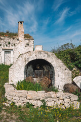 Beautiful white traditional old stone outdoor oven or fireplace in the countryside in Puglia...