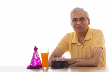 Sad senior man celebrating his birthday lonely