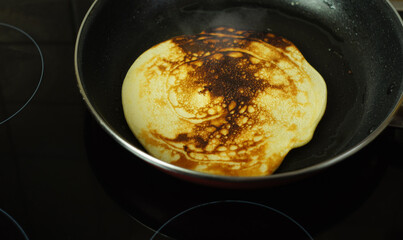 Handmade pancake is fried in a pan