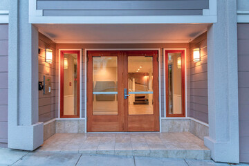 Fototapeta na wymiar Double door with glass and wood frames of a modern apartment building at San Francisco, CA