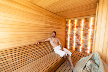 Young man relaxing in the sauna