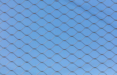 Metal mesh against the blue sky.