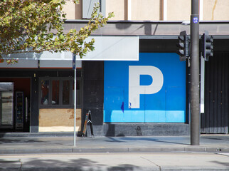 Big blue "Parking" sign on a city street
