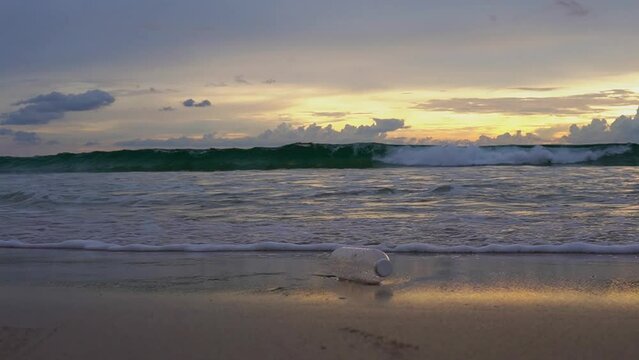 Plastic Waterbottle Gets Dragged Into The Sea By The Waves Of The Ocean