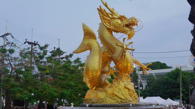 Reveal shot of the golden sea dragon statue (Hai Leng Ong) in Phuket, Thailand