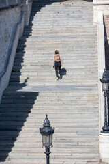 Fototapeta na wymiar people walking by stone stairs with backpack