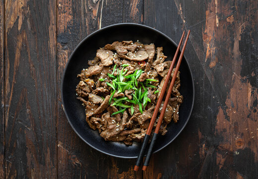 bulgogi with rice on wooden background, korean food, top view, copy space
