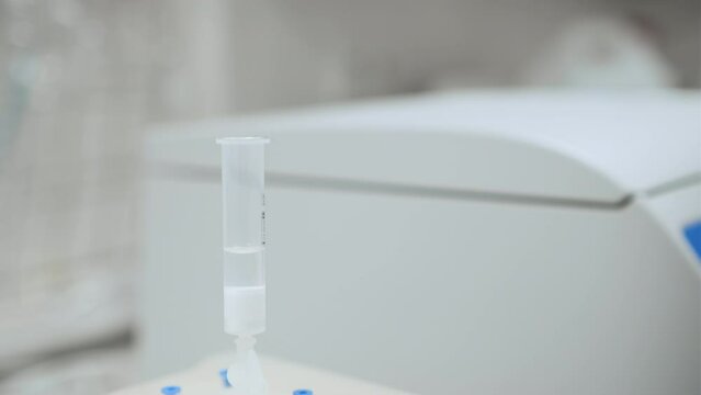 Scientist actives cartridge in SPE manifold with a solvent. Vacuum solid phase extraction for food analysis. 