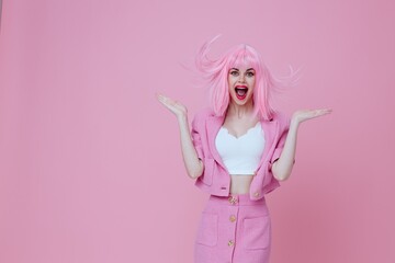Fototapeta na wymiar Beautiful fashionable girl bright makeup pink hair glamor pink background unaltered