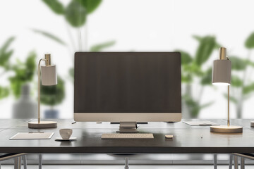Close up of empty mock up computer screen on desktop in modern coworking office interior with equipment, furniture, coffee cup, decorative plants and matte glass partition background.