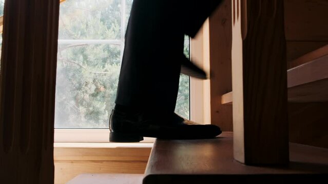 businessman climbs stairs close-up on his feet