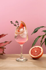 Mocktail Paloma. Refreshing grapefruit cocktail with ice and thyme. Cocktail of fresh pink Paloma