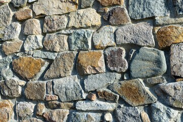 Background from a wall with stones in sunlight