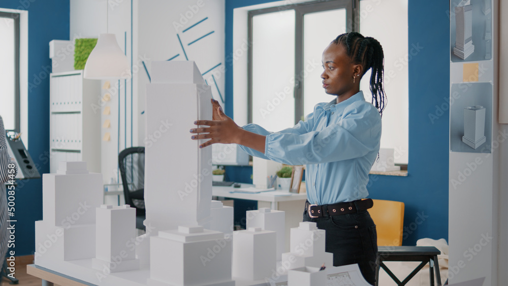 Poster woman placing blueprints plan on table to design building model and construction layout. architect u